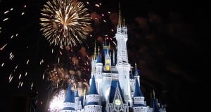 Cinderella Castle at Disney World sparkles under a night sky as vibrant fireworks light up the park for guests.