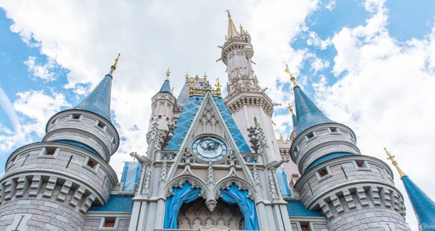 Cinderella Castle rises majestically at Disney World, its blue turrets crowned by clouds—the Magic Kingdom’s unforgettable centerpiece.