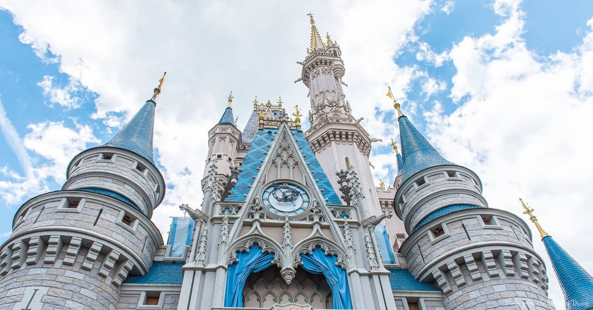 Cinderella Castle rises majestically at Disney World, its blue turrets crowned by clouds—the Magic Kingdom’s unforgettable centerpiece.