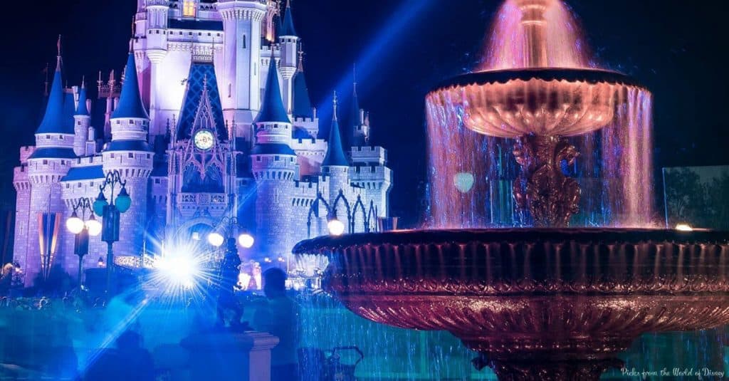 Cinderella Castle and shimmering fountains glow blue and purple at night—ideal for first-time visitors chasing Disney magic.