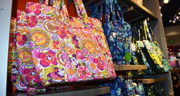 Tote bags with Disney floral and character prints line the shelves—ideal accessories for your next trip to Walt Disney World.