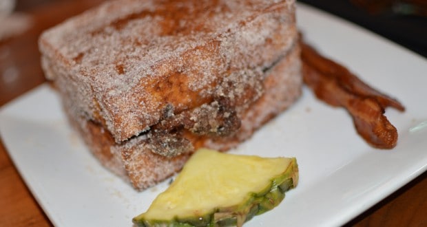 French toast dusted with sugar, pineapple, and crispy bacon at Kona Café—savor this fan-favorite Disney World breakfast!.