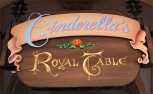 Cinderella’s Royal Table sign at Disney World features a pumpkin graphic, welcoming guests to this magical dining experience.