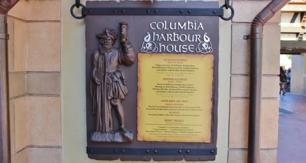 Columbia Harbour House menu sign with sailor mascot and tasty choices on a tan wall—classic Magic Kingdom dining charm.