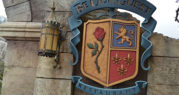 Be Our Guest Restaurant sign with a rose, lion, and fleur-de-lis shield—one of Walt Disney World's top dining experiences.