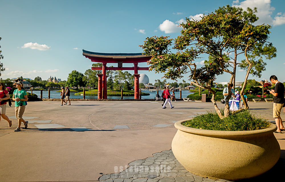 The iconic red torii gate by the shimmering Epcot Japan Pavilion lake invites guests to explore this stunning Disney World landmark.