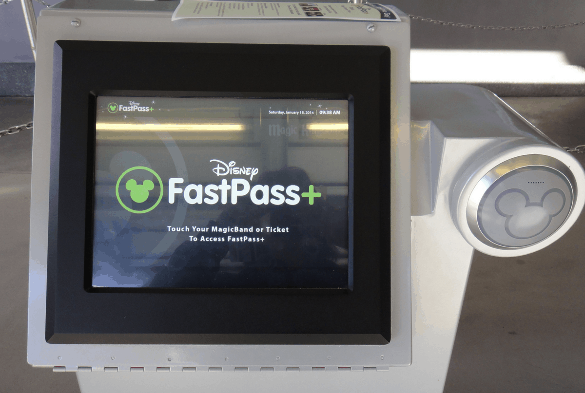 FastPass+ kiosk screen at Disney World, showing instructions to tap your MagicBand or park ticket for FastPass+ access.