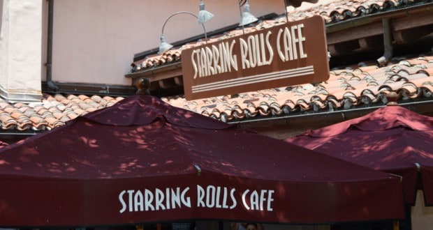 Maroon umbrellas and the "Starring Rolls Cafe" sign outside this Hollywood Studios eatery with its signature tiled roof.