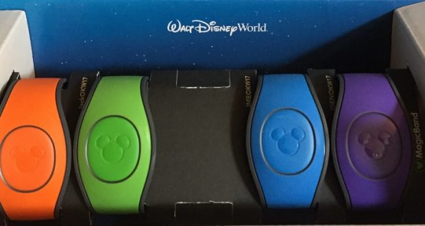 Five vibrant Disney MagicBands in a box, Walt Disney World branding behind—your key to seamless park entry and magical ease.