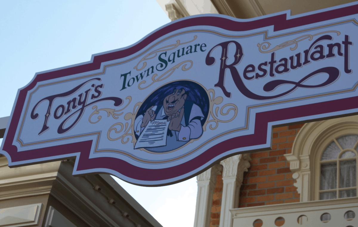 Tony’s Town Square Restaurant sign at Magic Kingdom, with a cartoon chef and menu inviting guests to classic Disney dining.