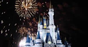 Cinderella Castle glows against the night sky, as vibrant fireworks light up Magic Kingdom for an unforgettable Disney experience.