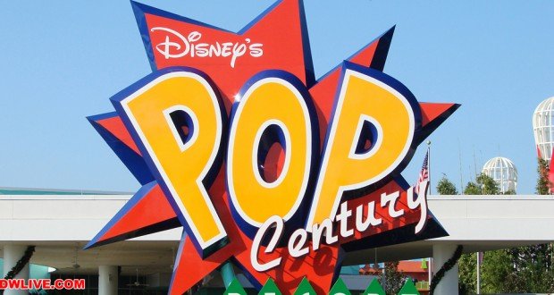 Vibrant "Disney's Pop Century" marquee welcomes guests, standing bright against blue skies at the resort entrance.