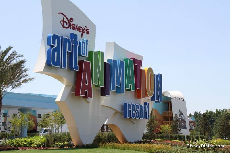 Disney’s Art of Animation Resort sign pops with color amid palm trees—an iconic Disney World photo spot for park enthusiasts.