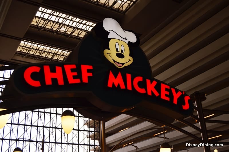 Chef Mickey’s glowing red sign and smiling chef Mickey welcome Disney fans, marking a must-snap dining spot at Walt Disney World.