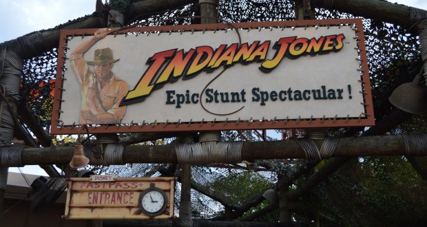Indiana Jones Epic Stunt Spectacular!" sign at Disney’s Hollywood Studios, with Indiana Jones art and Fastpass Entrance clock.