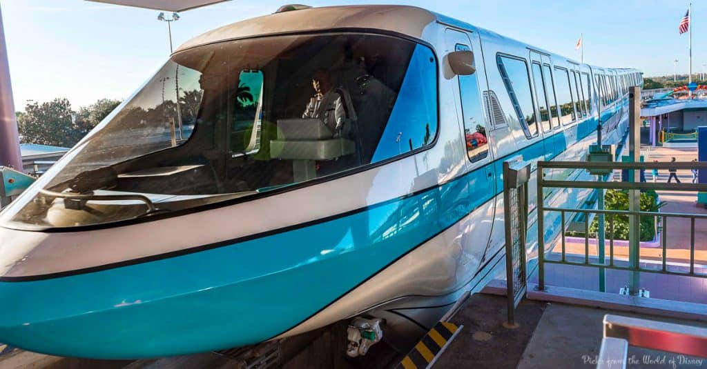 Disney World’s iconic blue and white monorail at the station, driver in view up front—essential for every Disney fan's visit.
