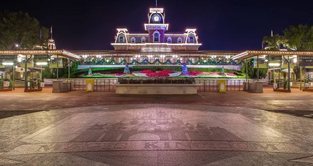The Magic Kingdom entrance shines at night, featuring a vibrant floral Mickey design—a must-see for every Disney World visitor.