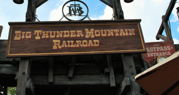 Big Thunder Mountain Railroad entrance sign welcomes guests at Magic Kingdom, with FastPass nearby for thrill-seeking fans.