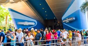 Guests line up outside Spaceship Earth at Epcot, eager to experience the ride and spot Hidden Mickeys during their wait.