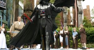 Darth Vader leads young Jedi with toy lightsabers at Walt Disney World, bringing Star Wars adventures to life for guests.