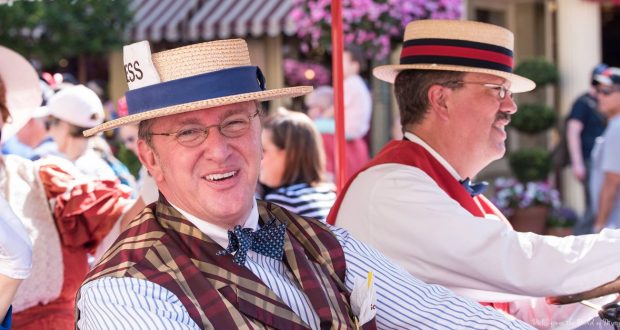 Dapper Dans in vintage attire and straw hats delight guests with a sunny outdoor performance on Main Street, U.S.A.