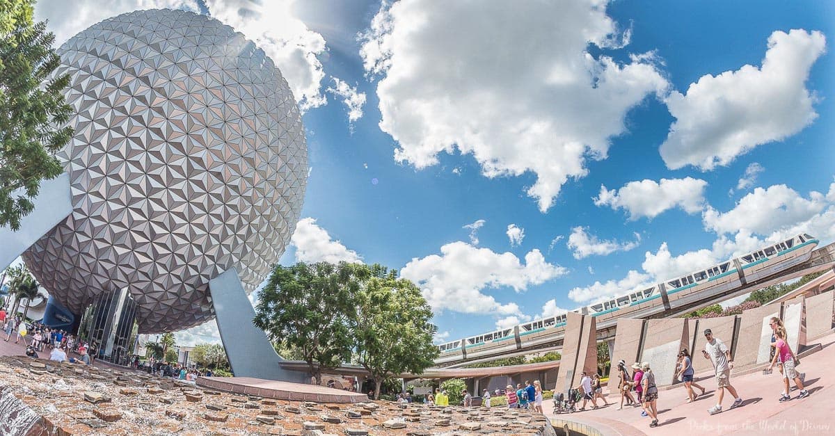 Spaceship Earth, the Epcot monorail gliding by, and excited guests exploring Disney’s futuristic park under a vibrant sky.