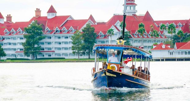 A classic Disney ferry glides across the lake in front of Disney's Grand Floridian Resort, evoking signature Disney magic.