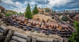 The mine train coaster with barrel cars races through rocky forests, a timeless favorite for Disney World thrill-seekers.