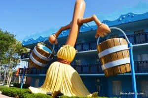 Fantasia’s iconic broomstick carrying buckets stands tall by Disney’s blue resort, a whimsical Disney World photo op in the sun.