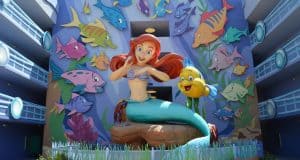 Ariel and Flounder shine in a lively mural with bright Disney fish, capturing the enchanting spirit of Walt Disney World.