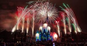 Dazzling fireworks illuminate Cinderella Castle at night as Disney World guests capture the magical show on their phones.
