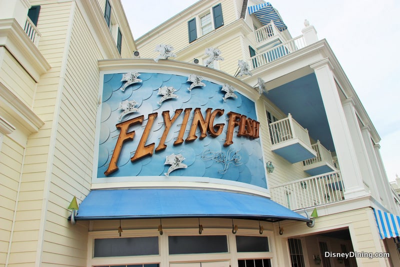 The whimsical blue-and-white Flying Fish Café at Disney’s BoardWalk features playful fish décor and a bold marquee sign.