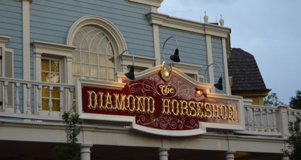 The Diamond Horseshoe sign gleams atop its ornate, balcony-adorned facade in Magic Kingdom at Walt Disney World Resort.