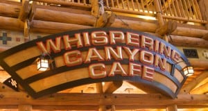 Whispering Canyon Cafe sign in a cozy, lodge-themed setting at Walt Disney World—one of the park’s must-try dining gems.
