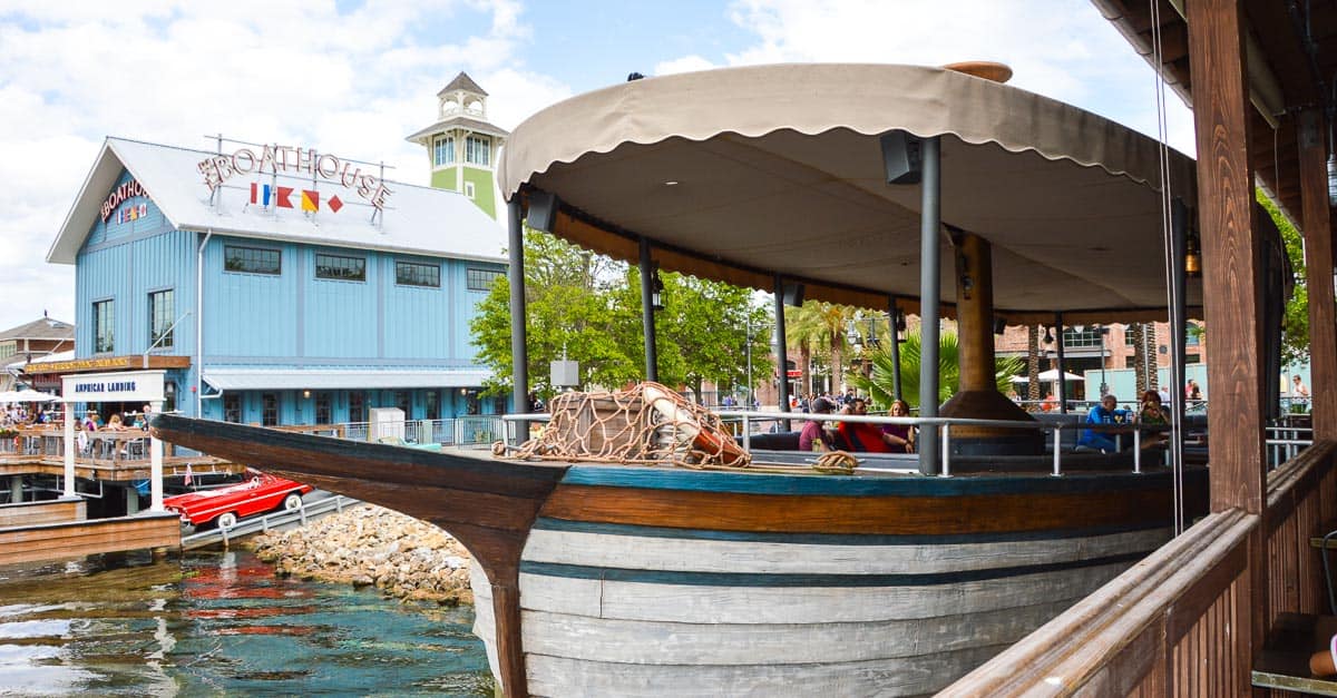 The iconic boat-shaped bar with canopy docks by the Boathouse at Disney Springs, adding to the waterfront magic and fun.