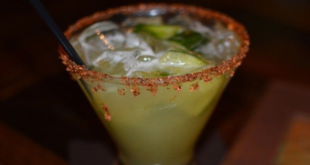 A chili-rimmed tequila cocktail with lime at Epcot’s La Cava del Tequila, ready for your World Showcase adventure.