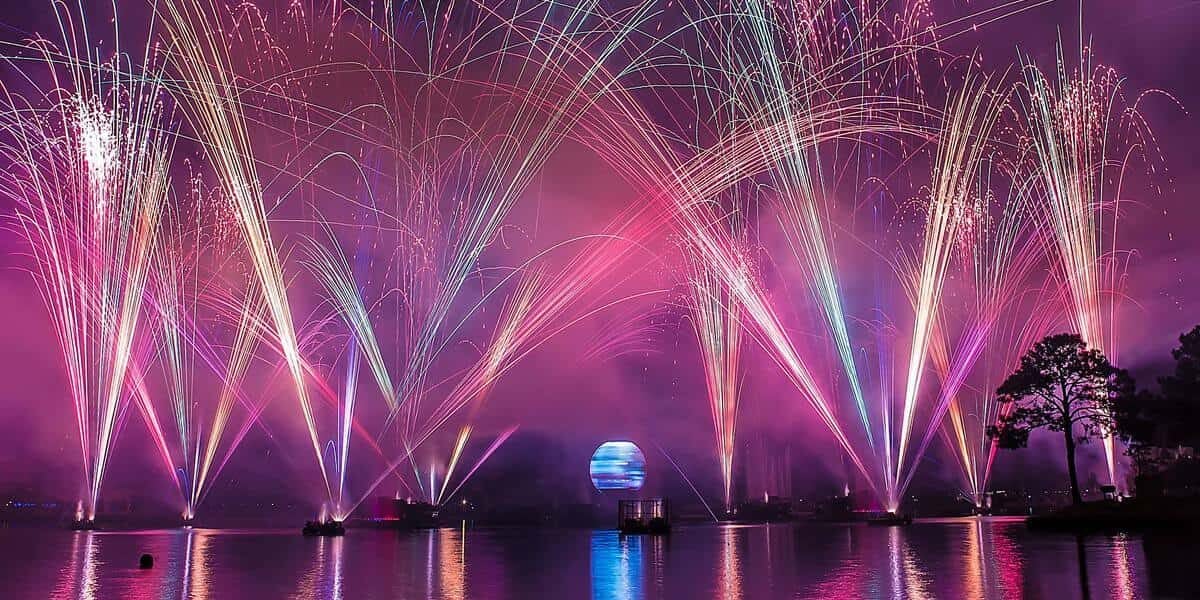 Spectacular fireworks dazzle above Disney World’s lake, their reflections shimmering as fans gather for the legendary nightly show.