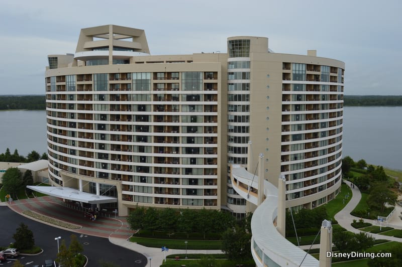 Sweeping Disney hotel with balconies overlooking the lake, linked by a sky bridge—ideal for deluxe villa stays near the parks.