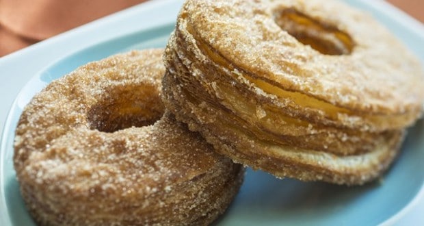 Two sugar-dusted cronuts stacked on a white plate—an iconic Disney World snack you’ll crave between park adventures.