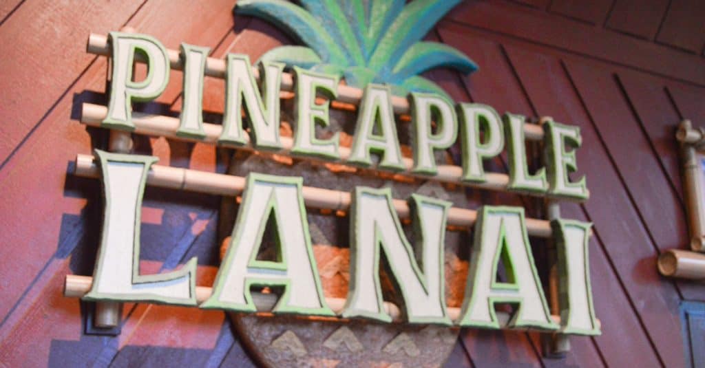Pineapple Lanai sign at Disney’s Polynesian Village Resort with its iconic stylized pineapple in the background.