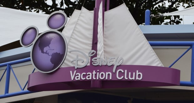 Disney Vacation Club’s vibrant purple sign with a Mickey globe logo shines on the awning, spotlighting member perks at Disney resorts.