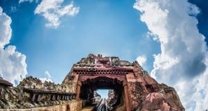 Expedition Everest’s coaster track dives into a rugged mountain, set against blue skies—an Animal Kingdom must-see adventure.