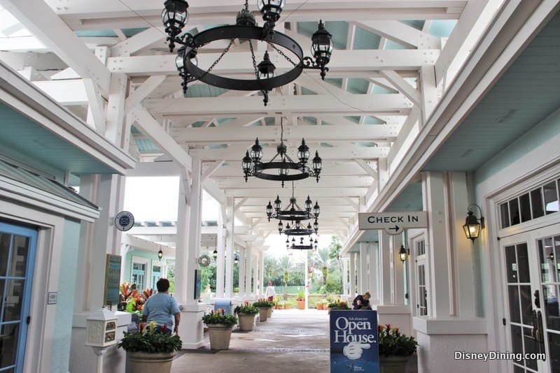 Old Key West Resort’s open house features a chandelier-lit, covered check-in area with white beams and themed event signage.