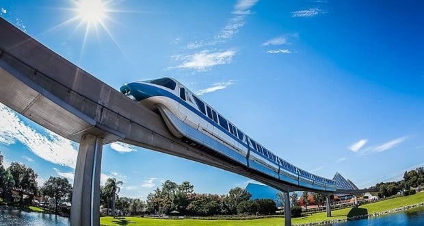 The Disney World Monorail glides above shimmering water under sunny skies, kicking off a legendary Monorail Bar Crawl.