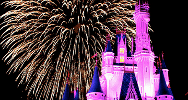 Cinderella Castle glows pink at Walt Disney World as dazzling fireworks burst overhead, creating a magical nighttime spectacle.
