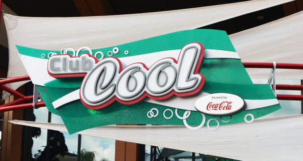 Club Cool’s classic green and white sign and Coca-Cola logo invite Epcot guests to cool off and sample international sodas.