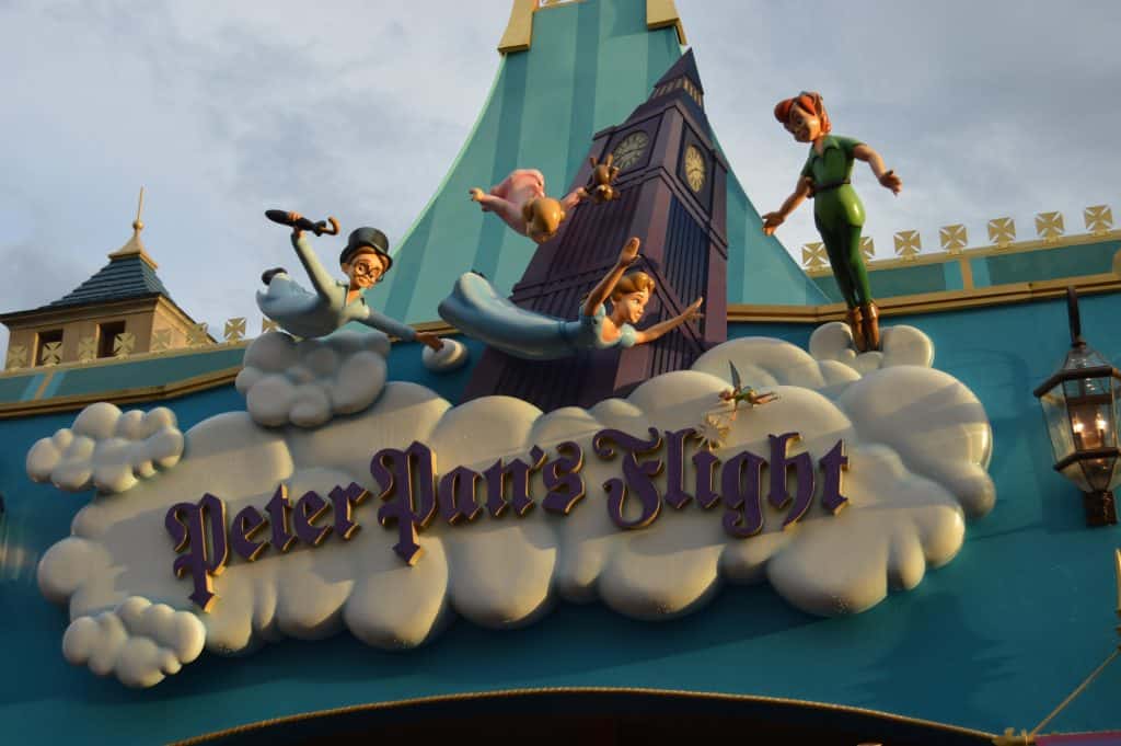 Peter Pan’s Flight sign at Magic Kingdom, featuring Peter, Wendy, John & Michael soaring above Big Ben—a beloved Disney classic.