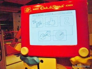 Etch A Sketch at Disney World challenges guests with a lively “Guess the Phrase” game, featuring playful sketched clues.