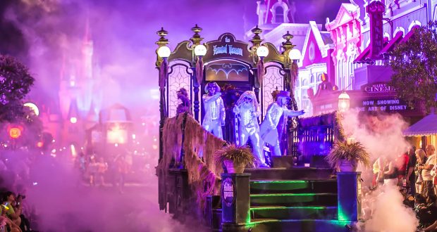 Ghostly parade floats draped in fog glide down Main Street at Mickey’s Not So Scary Halloween Party, thrilling Disney fans.