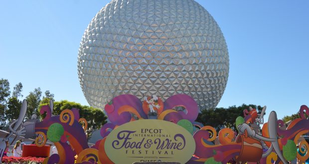 Spaceship Earth at Epcot gleams in the sunlight, decked out with vibrant Food and Wine Festival décor—pure Disney World magic.
